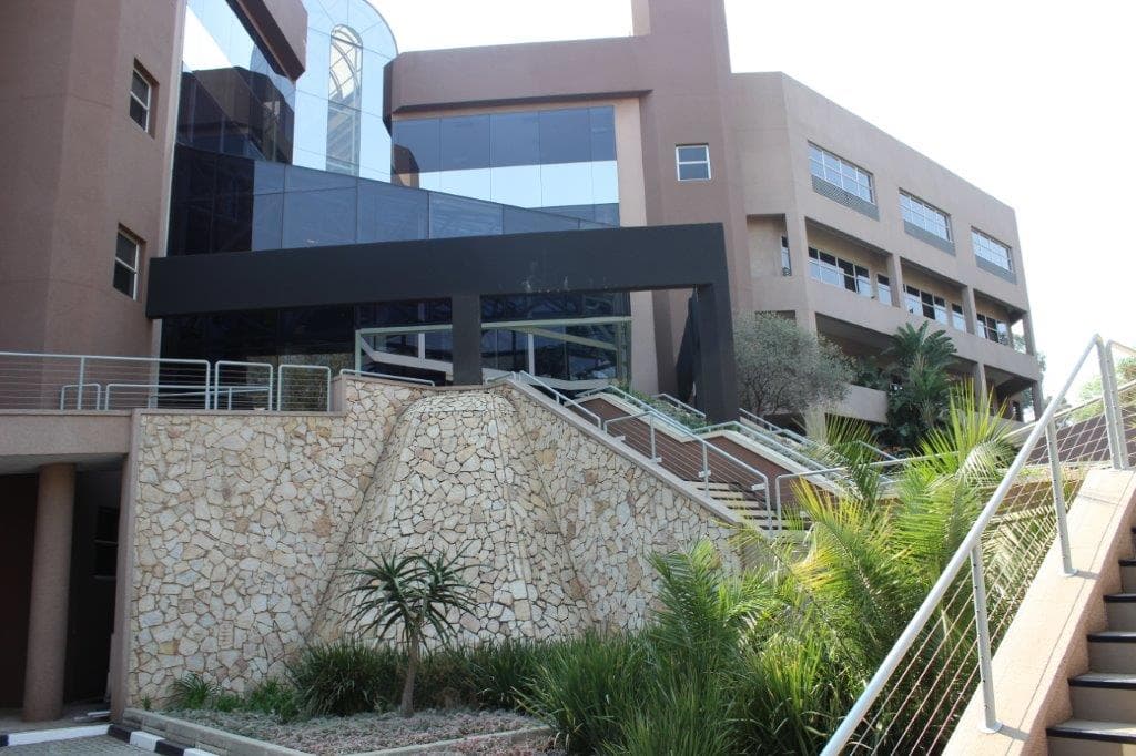 Entrance to Metropolitan Park, 8 Hillside Road, Parktown, with stairs leading up to the glass atrium